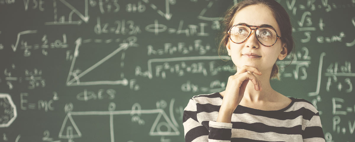 Woman thinking in front of chalkboard of math equations